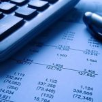 financial statement with calculator and pen