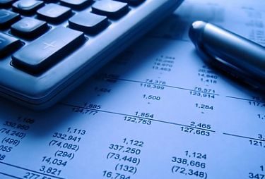 financial statement with calculator and pen