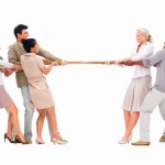 Business people pulling a rope against each other
