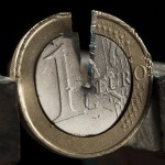 Photo illustration of damaged one Euro coin being held in a vise