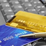 Closeup of credit cards and pen on computer keyboard
