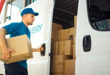 Courier Takes out Cardboard Box Package from Openned Delivery Van and Closes the Door. Delivering Postal Parcel to Customer.