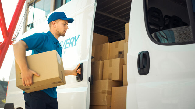 Courier Takes out Cardboard Box Package from Openned Delivery Van and Closes the Door. Delivering Postal Parcel to Customer. Courier Takes out Cardboard Box Package from Openned Delivery Van and Closes the Door. Delivering Postal Parcel to Customer.