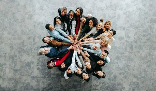 Top,View,Of,A,Diverse,Team,Of,People,Joining,Hands Top,View,Of,A,Diverse,Team,Of,People,Joining,Hands