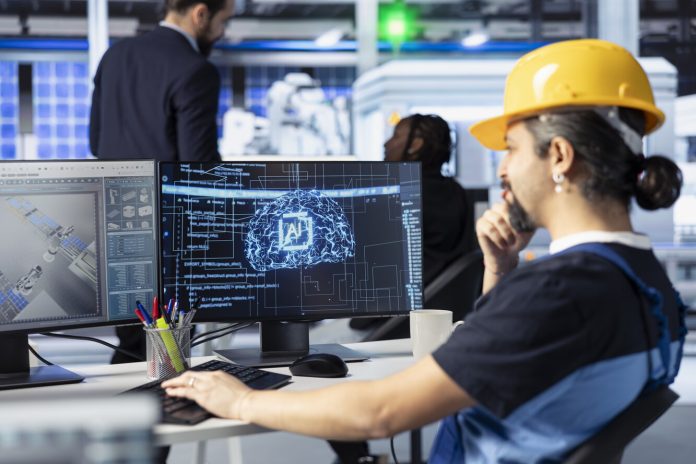 Engineer training AI models at workstation in solar panel production facility manutenzione predittiva